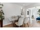 Bright dining room featuring a glass table, plush chairs and hardwood flooring at 2626 S Pennsylvania St, Denver, CO 80210