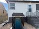 Charming exterior with a blue door leading to a finished basement and gray stair access at 2626 S Pennsylvania St, Denver, CO 80210
