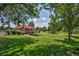 Expansive golf course view featuring a clubhouse with a wooden deck and lush green landscaping at 2626 S Pennsylvania St, Denver, CO 80210