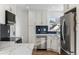 Contemporary kitchen featuring stainless appliances, white cabinets, and stunning countertops at 2626 S Pennsylvania St, Denver, CO 80210