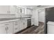 Basement kitchen features stainless appliances and white cabinetry at 2626 S Pennsylvania St, Denver, CO 80210