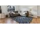 Cozy living room with a large window, comfortable seating and a modern patterned rug at 2626 S Pennsylvania St, Denver, CO 80210