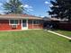 A well-maintained backyard with a lush lawn, a narrow walkway, and outdoor seating, ideal for relaxation and gatherings at 25 S Winona Ct, Denver, CO 80219