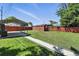 Large backyard featuring a covered parking area and a shed, ideal for storage and outdoor activities at 25 S Winona Ct, Denver, CO 80219