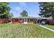 A well-maintained backyard with lush green grass and a red fence, perfect for outdoor activities at 25 S Winona Ct, Denver, CO 80219