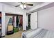 Cozy bedroom features carpet, ceiling fan, closet, and convenient access to an additional storage area at 25 S Winona Ct, Denver, CO 80219