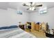 Basement bedroom with natural light from two windows, fan, and some storage at 25 S Winona Ct, Denver, CO 80219
