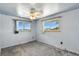 Serene bedroom with grey carpet, two windows and ceiling fan at 25 S Winona Ct, Denver, CO 80219