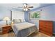Inviting bedroom showcasing a comfortable bed, dresser, and two windows to bring in natural light at 25 S Winona Ct, Denver, CO 80219