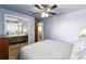 Spacious bedroom with a ceiling fan, mirrored closet, and ample natural light from the window at 25 S Winona Ct, Denver, CO 80219