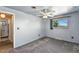 Bedroom with ceiling fan, grey carpet and view to ensuite bath at 25 S Winona Ct, Denver, CO 80219
