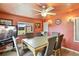 Inviting dining room with seating for six, neutral colored chairs and salmon walls at 25 S Winona Ct, Denver, CO 80219