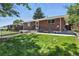 Charming brick home with a well-maintained front yard and cozy outdoor seating area at 25 S Winona Ct, Denver, CO 80219