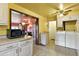 Functional kitchen space with washer/dryer and view into dining room at 25 S Winona Ct, Denver, CO 80219