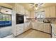 Bright kitchen featuring tile floors, white cabinets, and stainless steel appliances at 25 S Winona Ct, Denver, CO 80219