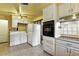 Kitchen with washer/dryer and stainless appliances next to dining area at 25 S Winona Ct, Denver, CO 80219