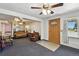 Spacious living room with a ceiling fan and lots of natural light coming from the windows at 25 S Winona Ct, Denver, CO 80219