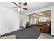 Spacious carpeted living room with adjacent rooms visible at 25 S Winona Ct, Denver, CO 80219