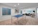 Basement area with a ping pong table, windows, and a cozy seating area at 8884 Miners St, Highlands Ranch, CO 80126