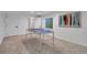 Versatile basement space with a ping pong table, windows, and easy access to other areas at 8884 Miners St, Highlands Ranch, CO 80126