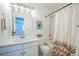 Bathroom with vanity, mirror, shower/tub and shower curtain at 8884 Miners St, Highlands Ranch, CO 80126