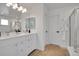 Bright bathroom with double vanity, large mirror, and shower/tub combo with white tile at 8884 Miners St, Highlands Ranch, CO 80126