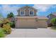 Front exterior showcasing a 3-car garage and well-maintained driveway in a cozy home at 8884 Miners St, Highlands Ranch, CO 80126