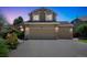Charming two-story home featuring a three-car garage, well-maintained lawn, and mature trees at 8884 Miners St, Highlands Ranch, CO 80126
