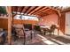 Backyard patio featuring shaded dining area with pergola, complete with brick pavers and privacy fencing at 2335 Stout St, Denver, CO 80205