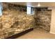Unfinished basement showcasing historic stone foundation and small window, offering potential for storage or renovation at 2335 Stout St, Denver, CO 80205
