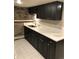 Basement kitchen featuring updated counters, stone accent wall, and ample cabinet storage at 2335 Stout St, Denver, CO 80205