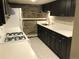 Basement kitchen featuring white appliances, stone accent wall, and updated counters at 2335 Stout St, Denver, CO 80205
