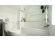Bright bathroom featuring a bathtub with glass door, white tile surround, and a modern toilet at 2335 Stout St, Denver, CO 80205