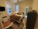 Comfortable bedroom with hardwood floors, natural light, and a view to an ensuite bathroom at 2335 Stout St, Denver, CO 80205