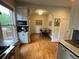 Open dining area with hardwood floors and arched doorway, filled with natural light at 2335 Stout St, Denver, CO 80205