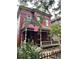 Charming red-brick Victorian home with a inviting porch, well-manicured landscaping and an American flag waving at 2335 Stout St, Denver, CO 80205
