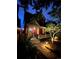Beautifully-lit Victorian home at twilight, featuring a cozy front porch and charming landscaping at the walkway at 2335 Stout St, Denver, CO 80205