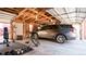 Spacious garage featuring a vehicle, home gym and ample storage on an unfinished ceiling with track lighting at 2335 Stout St, Denver, CO 80205