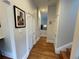 Hallway featuring hardwood floors, neutral walls, and classic trim details and doors at 2335 Stout St, Denver, CO 80205