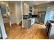 Open kitchen with stainless steel appliances, bright cabinets, and hardwood floors at 2335 Stout St, Denver, CO 80205