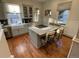 Updated kitchen features a large island with seating, stainless steel appliances, and hardwood floors at 2335 Stout St, Denver, CO 80205