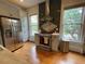 Well-lit kitchen with stainless steel appliances, tiled backsplash, and wood floors at 2335 Stout St, Denver, CO 80205