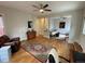 Spacious living room showcasing hardwood floors, two seating areas, and a stylish display cabinet at 2335 Stout St, Denver, CO 80205