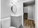A modern bathroom with grey vanity and decorative tile floor at 5373 S Prescott St, Littleton, CO 80120