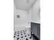 Bathroom features white subway tiles, a stylish vanity, and mosaic floor tiles at 5373 S Prescott St, Littleton, CO 80120