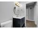 Bathroom features a gold round mirror, modern vanity, and stylish lighting at 5373 S Prescott St, Littleton, CO 80120