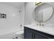Bathroom with white subway tiles, navy vanity, and custom starburst floor tiles at 5373 S Prescott St, Littleton, CO 80120