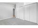 Spacious bedroom with neutral carpet, multiple closets, and a view to the hall at 5373 S Prescott St, Littleton, CO 80120
