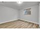 A bright bedroom featuring a window and light wood flooring at 5373 S Prescott St, Littleton, CO 80120