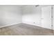 Bedroom featuring neutral walls, plush gray carpet, and a white door at 5373 S Prescott St, Littleton, CO 80120